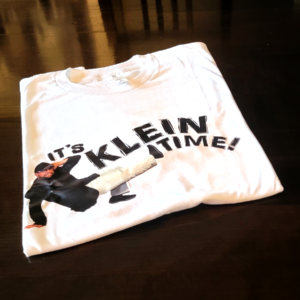 It's Klein Time Tshirt folded and sitting on a table